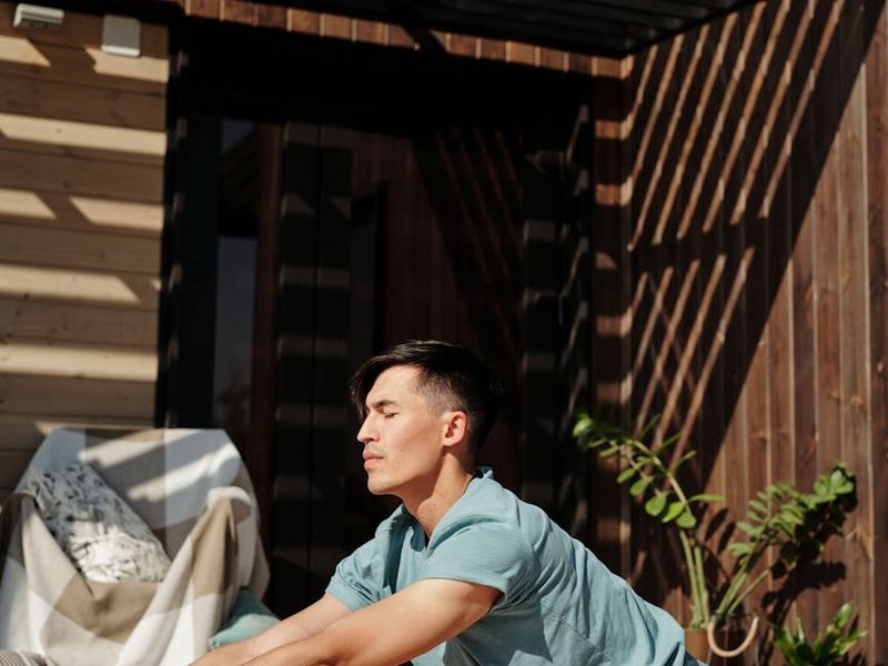 A man in deep concentration during a floor exercise routine.